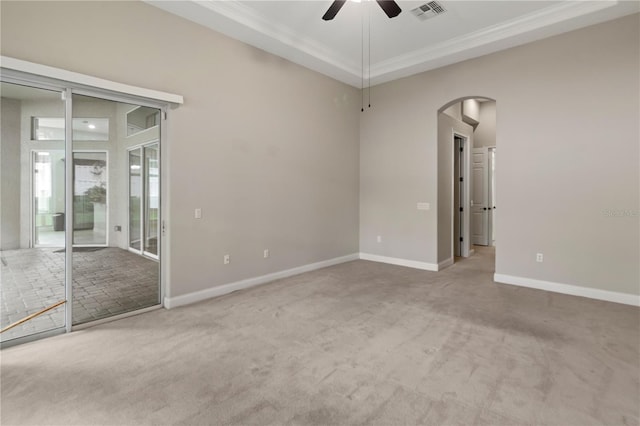 carpeted spare room with ceiling fan and ornamental molding