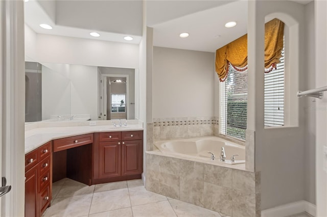 bathroom featuring vanity, tiled tub, and tile patterned floors