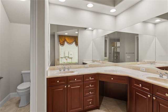 bathroom featuring vanity, tile patterned floors, and toilet