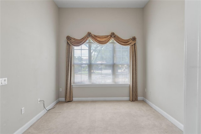 unfurnished room featuring light colored carpet