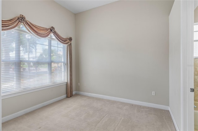 empty room featuring light carpet