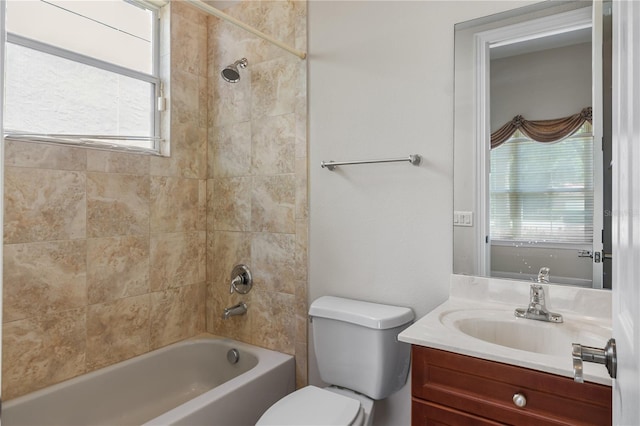 full bathroom with vanity, tiled shower / bath combo, and toilet