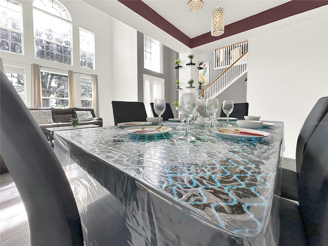 dining space with a towering ceiling