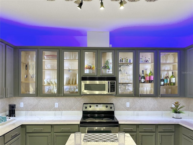 kitchen with appliances with stainless steel finishes and decorative backsplash