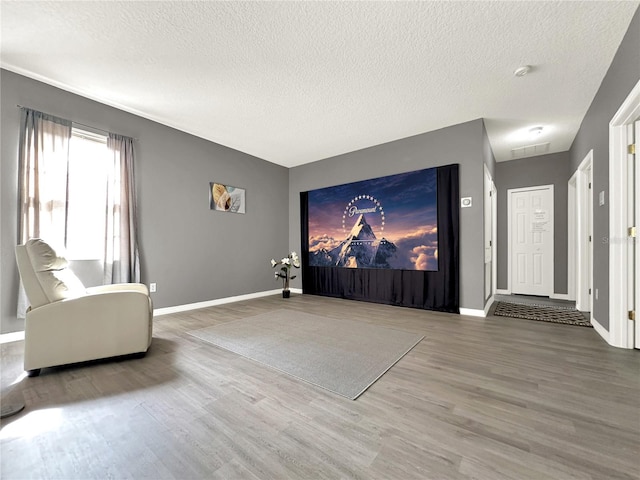 interior space with wood-type flooring and a textured ceiling