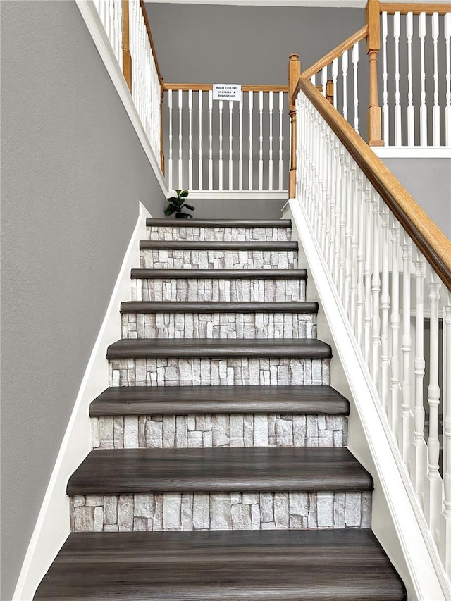 stairway with hardwood / wood-style floors