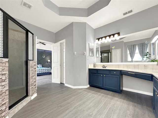 bathroom with vanity, hardwood / wood-style floors, and ceiling fan