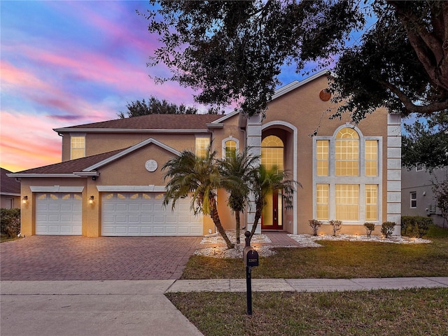 view of front of property with a lawn and a garage