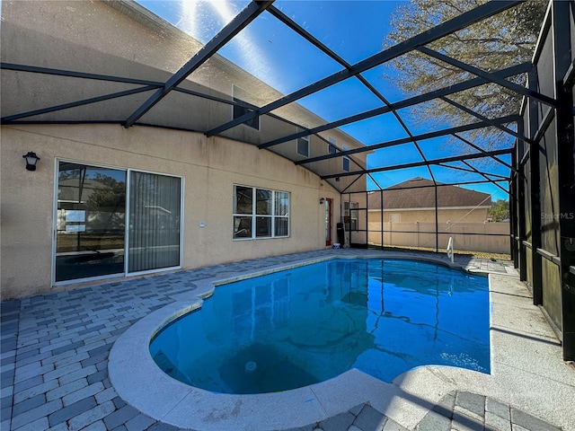 view of pool featuring glass enclosure