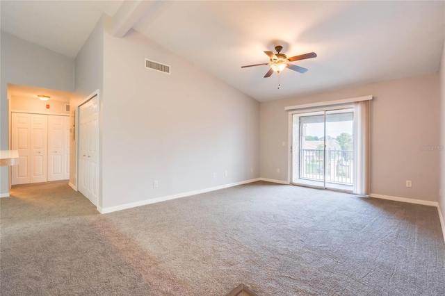 empty room featuring lofted ceiling, ceiling fan, and carpet floors