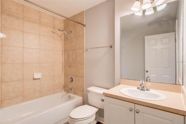 full bathroom featuring toilet, vanity, and tiled shower / bath