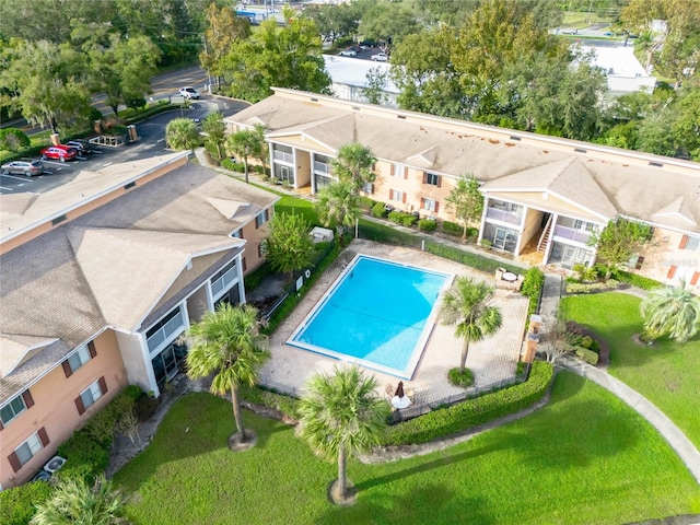 view of pool with a patio area and a yard