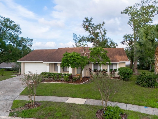 view of front of house with a garage and a front yard