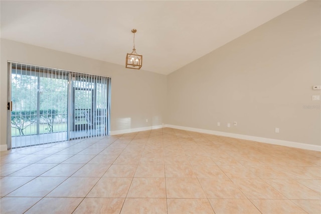 tiled spare room with a chandelier and lofted ceiling