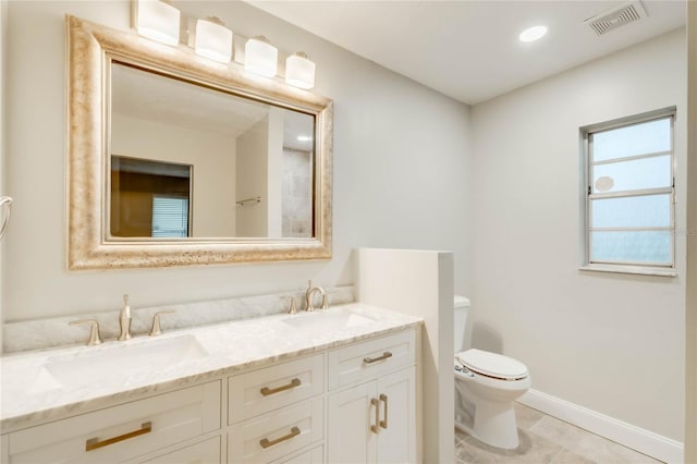 bathroom featuring toilet, vanity, and tile patterned floors