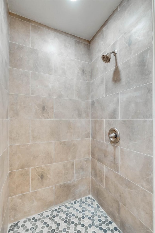 bathroom with tiled shower