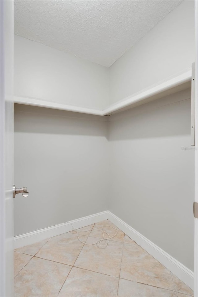 spacious closet featuring tile patterned flooring