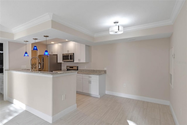 kitchen with white cabinets, appliances with stainless steel finishes, and crown molding