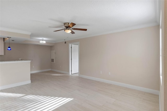 empty room featuring a textured ceiling, ceiling fan, and crown molding