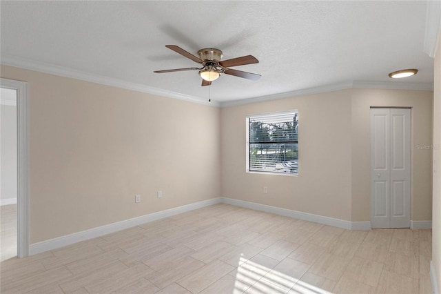 empty room with ceiling fan and ornamental molding