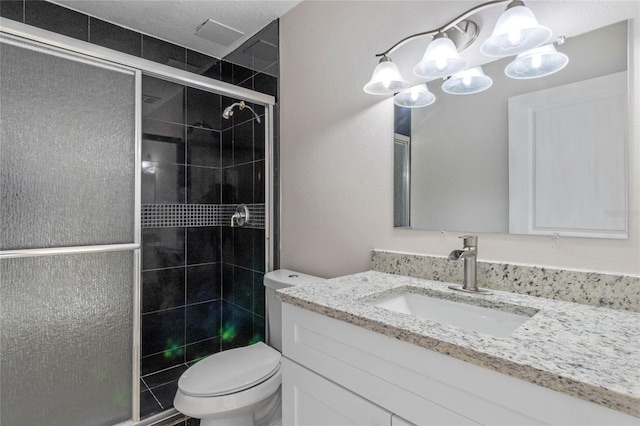 bathroom with an enclosed shower, vanity, and toilet