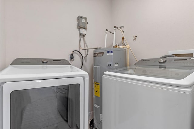 laundry area with washing machine and dryer and water heater