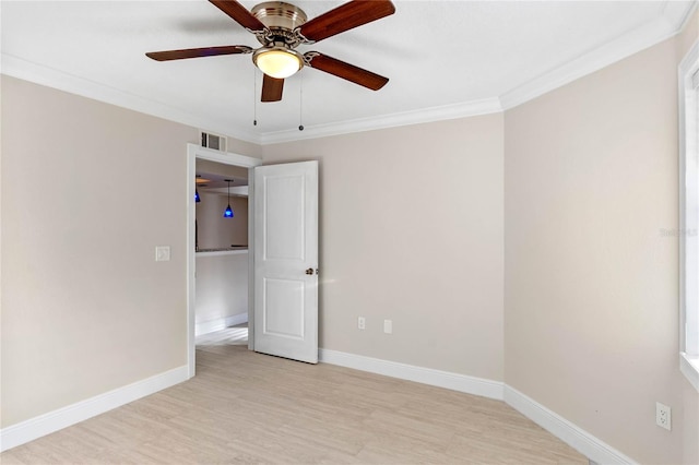 empty room featuring ceiling fan, light hardwood / wood-style floors, and ornamental molding