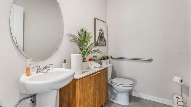 bathroom with tile patterned floors, toilet, and sink