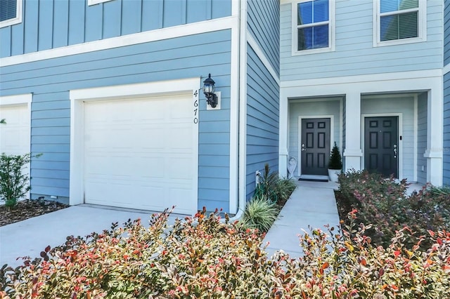 doorway to property with a garage