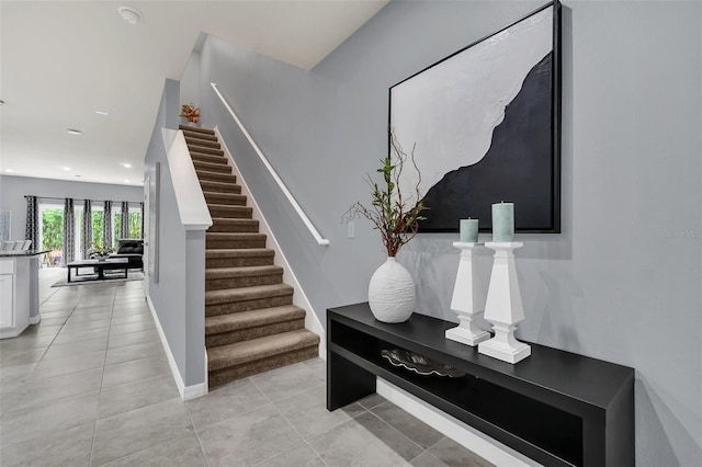 stairway with tile patterned floors