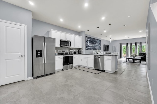 kitchen featuring stainless steel appliances, white cabinetry, decorative light fixtures, stone counters, and kitchen peninsula