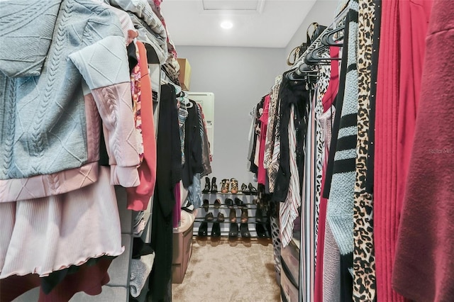 spacious closet featuring light carpet