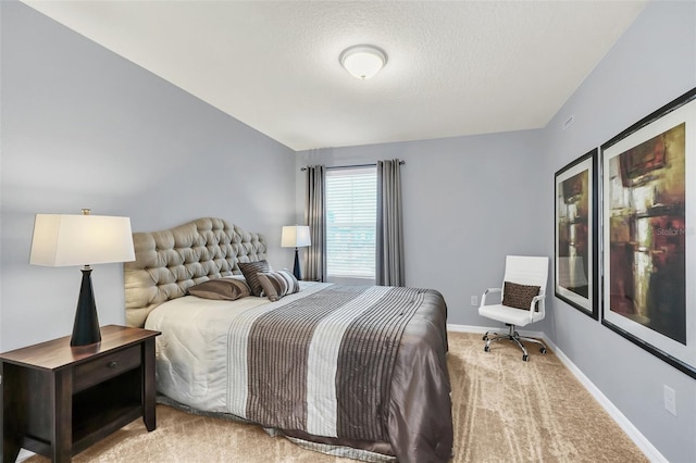 bedroom featuring carpet flooring and a textured ceiling