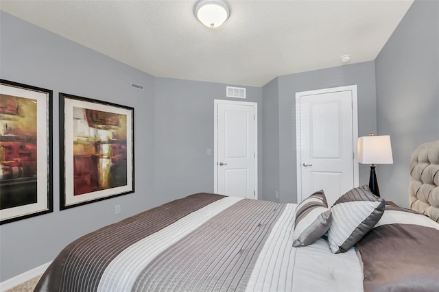 carpeted bedroom with a textured ceiling