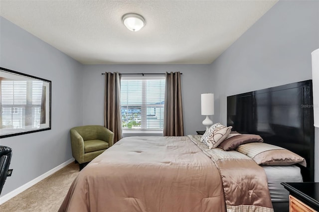 bedroom with a textured ceiling and carpet flooring