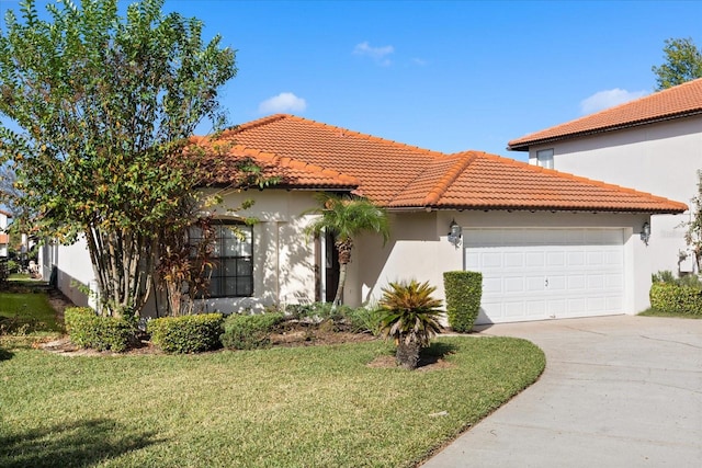 mediterranean / spanish-style house featuring a garage and a front lawn