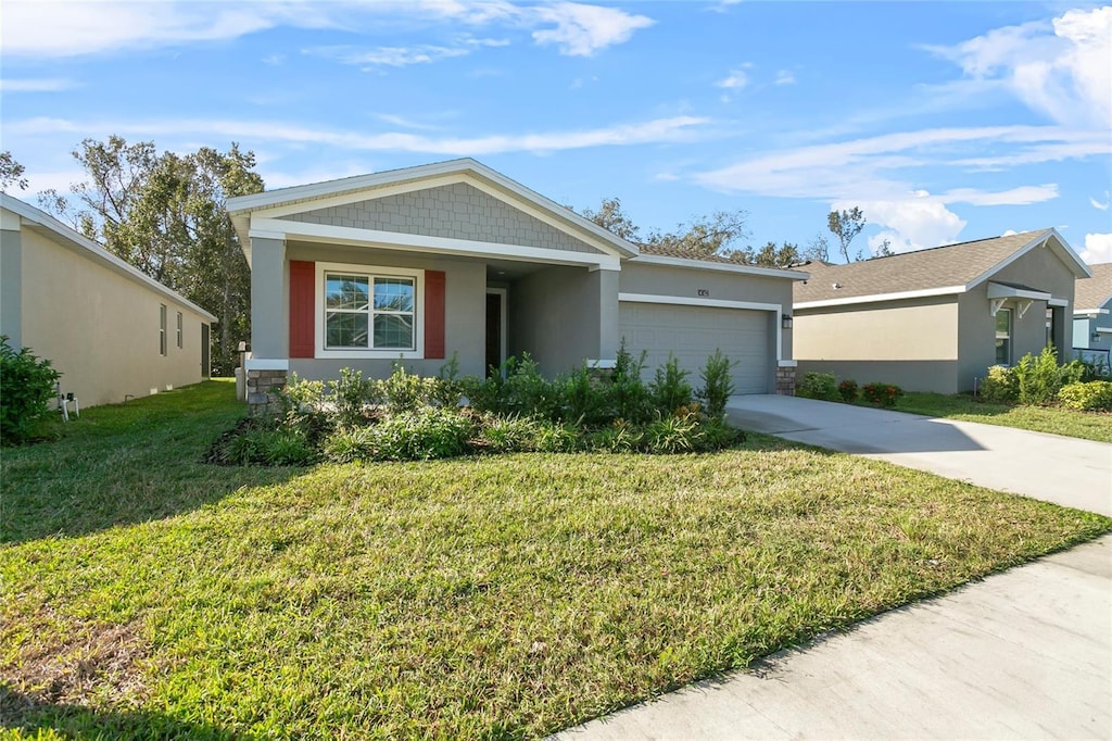 ranch-style home with a garage and a front lawn