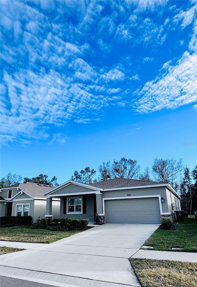 single story home with a front lawn and a garage