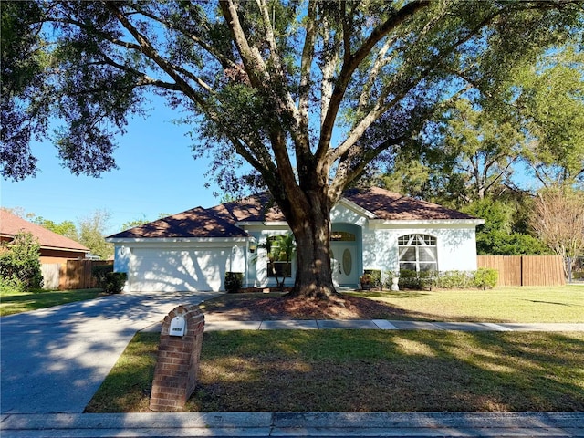 view of front of home with a garage and a front lawn