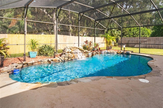 view of pool featuring pool water feature, a patio area, and glass enclosure