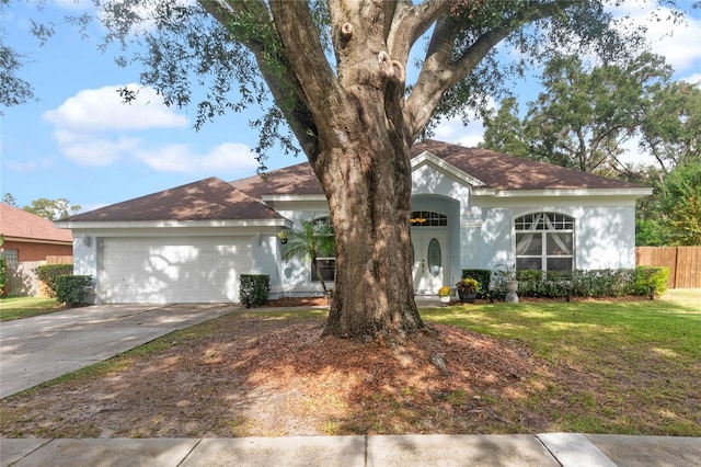 view of front of house with a garage and a front yard