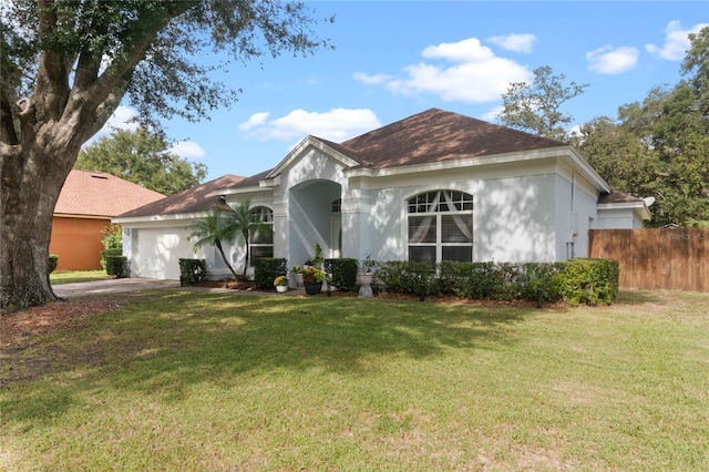 view of front of property with a garage and a front yard