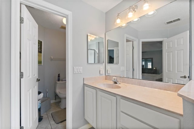 bathroom with tile patterned floors, vanity, and toilet