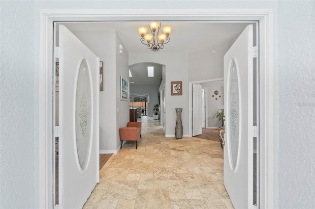 corridor with a chandelier