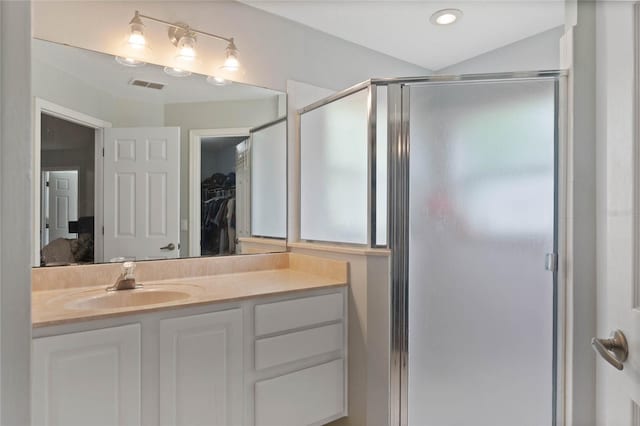 bathroom featuring vanity and an enclosed shower