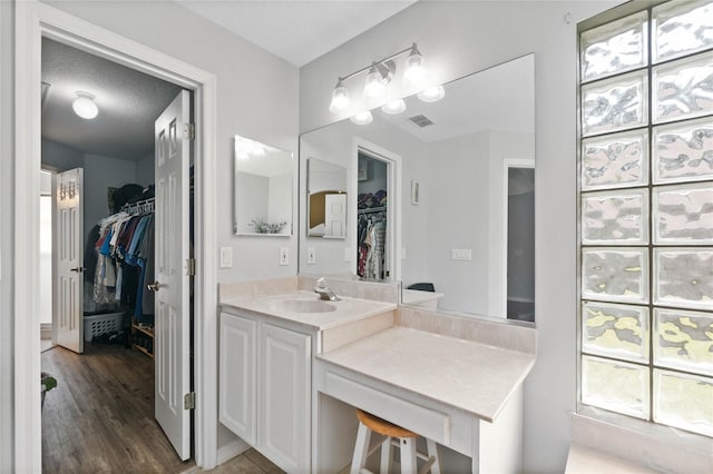 bathroom with vanity, hardwood / wood-style flooring, and a textured ceiling