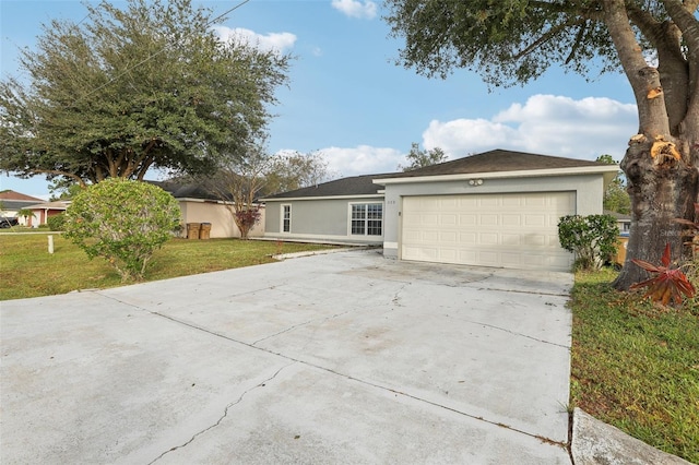 ranch-style house featuring a front lawn and a garage