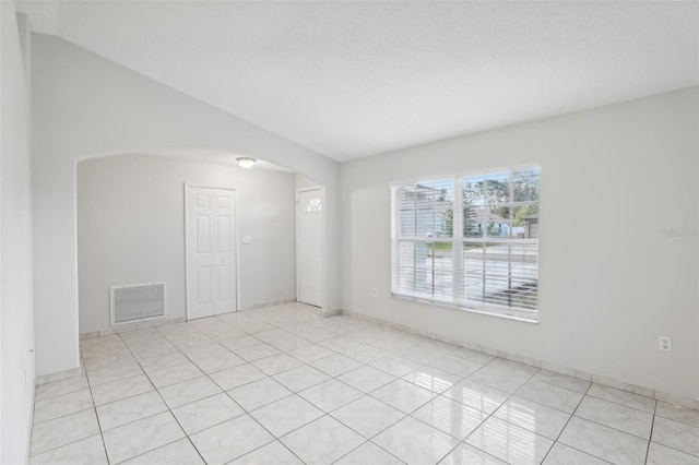 unfurnished room featuring light tile patterned floors