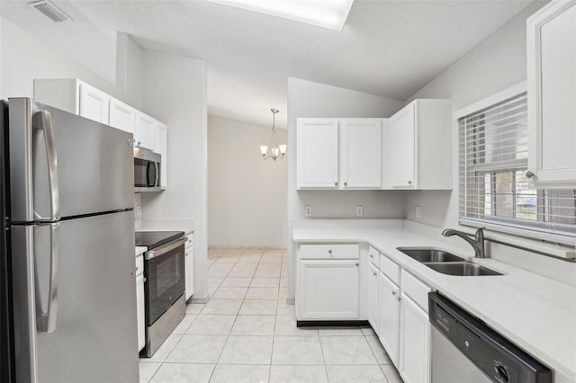 kitchen featuring white cabinetry, sink, lofted ceiling, and stainless steel appliances