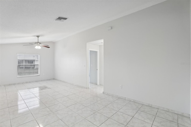 unfurnished room featuring ceiling fan, light tile patterned flooring, and vaulted ceiling